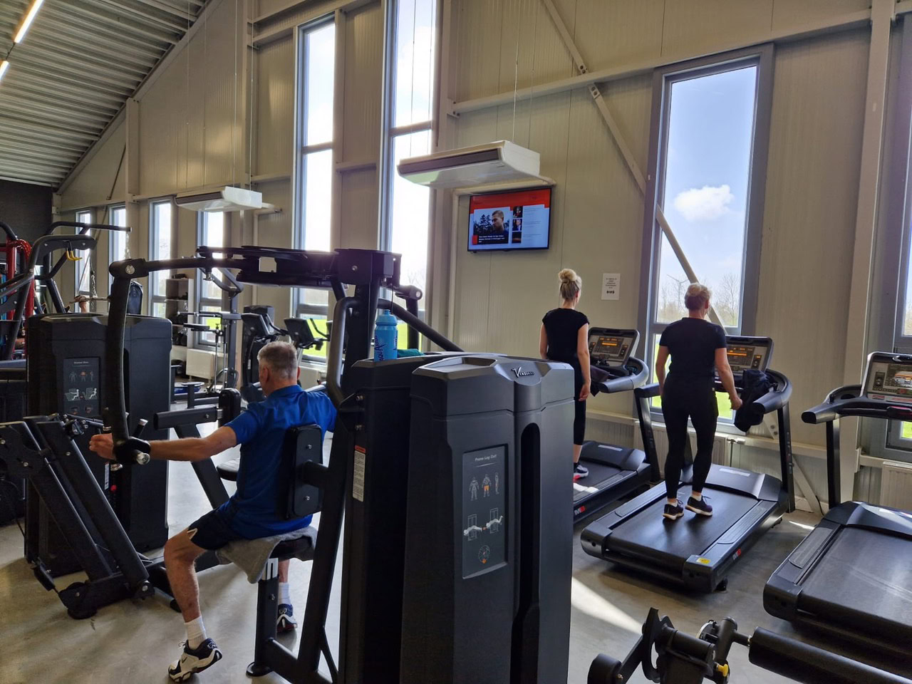 Sporters kijken naar scherm tijdens het trainen